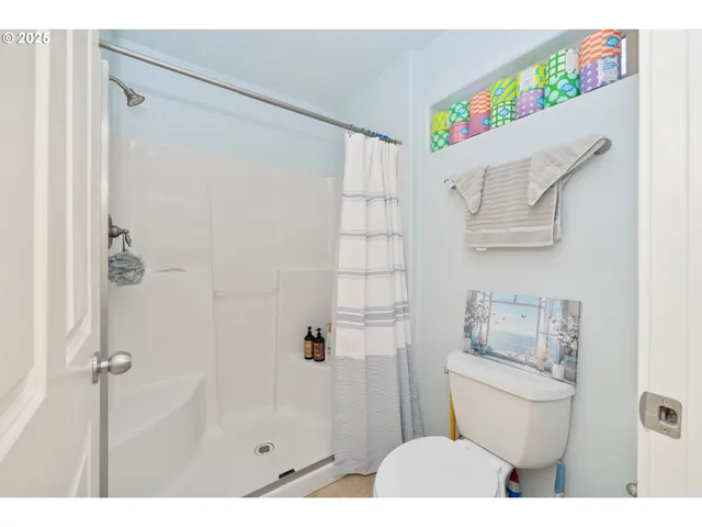 a bathroom with a toilet sink and shower