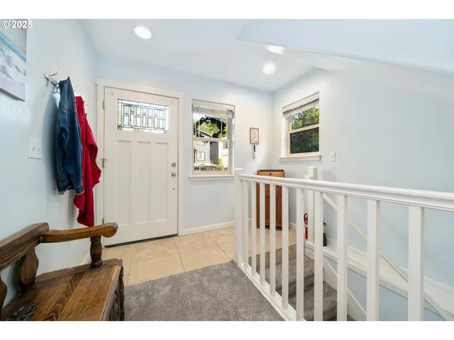 a view of a living room with furniture and a flat screen tv