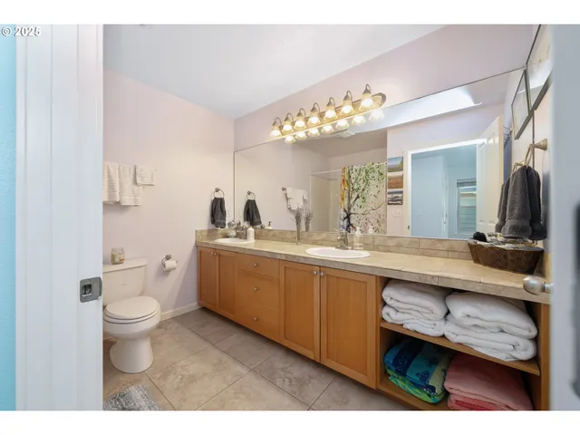 a bathroom with a sink toilet and shower curtain