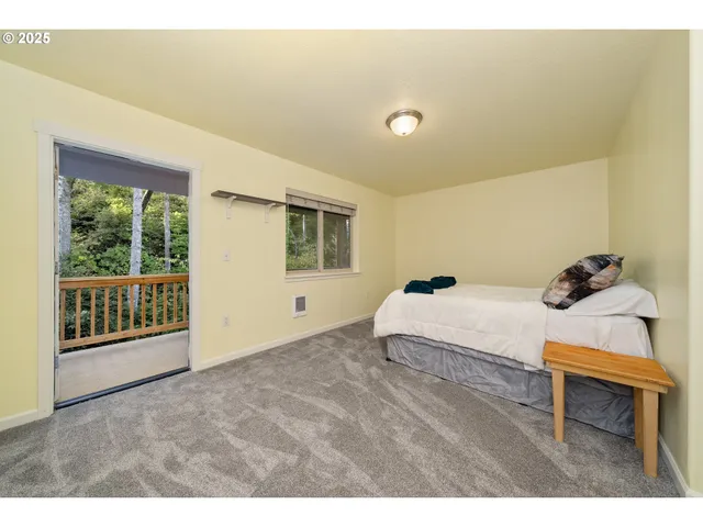 a living room with a bed furniture and a window