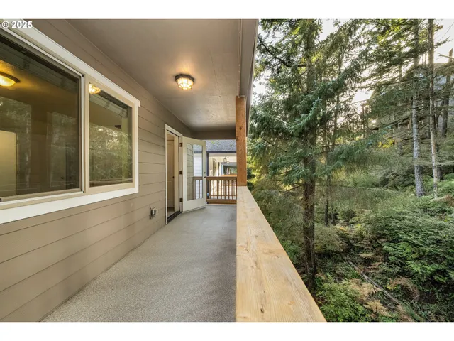 a kitchen with kitchen island microwave and view of living room