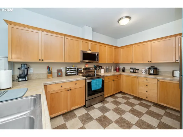 a kitchen with a sink a stove and a refrigerator