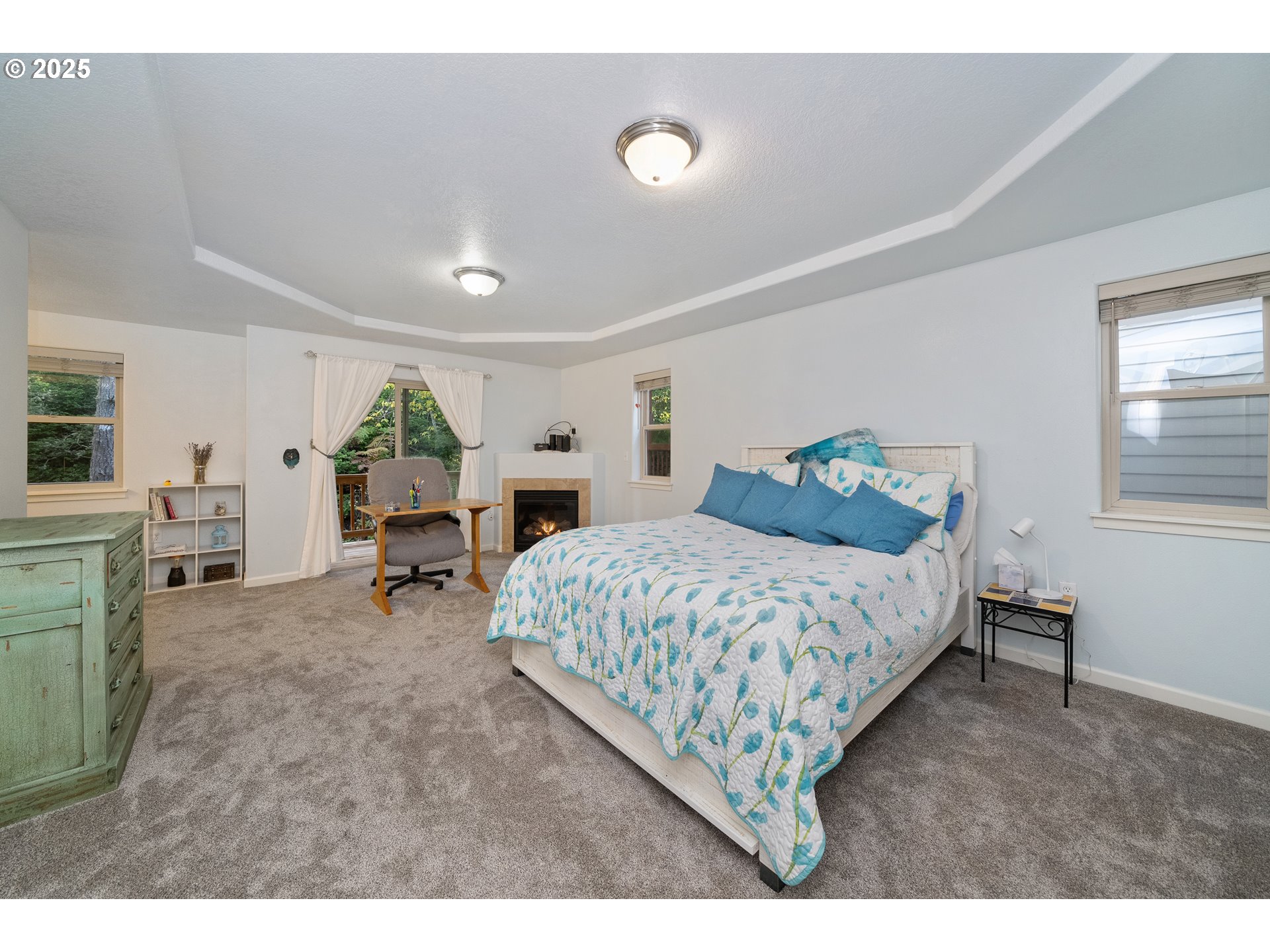 140 Breezee Way Tillamook, OR 97141 - Photo 5 of 46 a spacious bedroom with a bed and a table in it