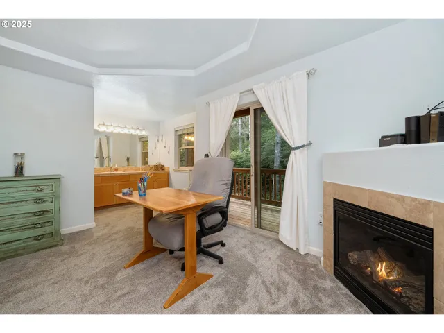 a living room with furniture a fireplace and a table