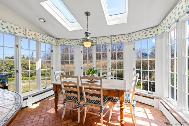 a dining room with wooden floor glass table and chairs
