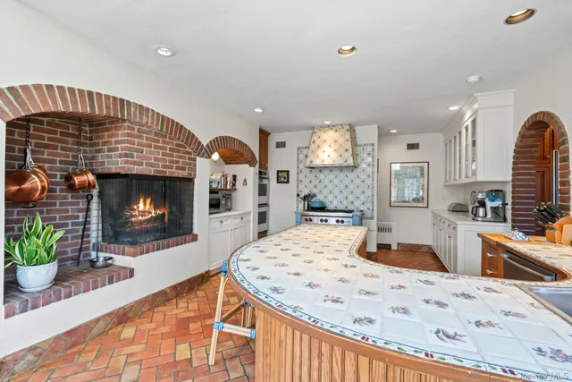 a living room with fireplace furniture and a fireplace