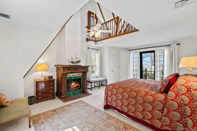 a bedroom with a bed a fireplace and a window