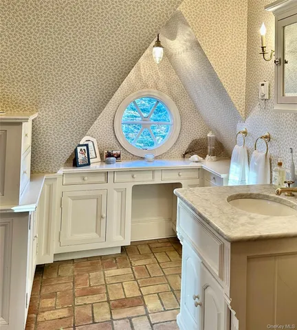 a bathroom with a sink a vanity and a mirror