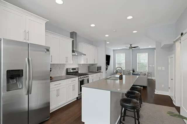 a kitchen with white cabinets and stainless steel appliances