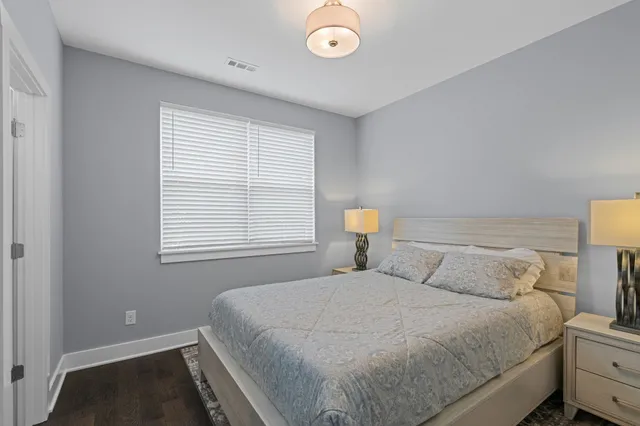 a bedroom with a bed and a lamp