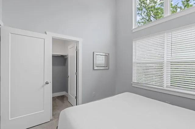 a bedroom with a bed and a window