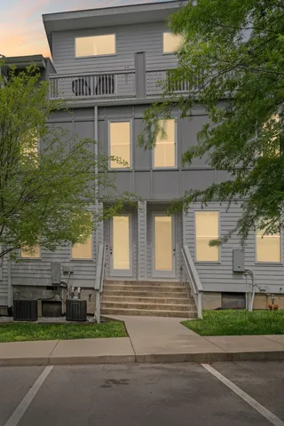 a front view of a house with a garden and plants