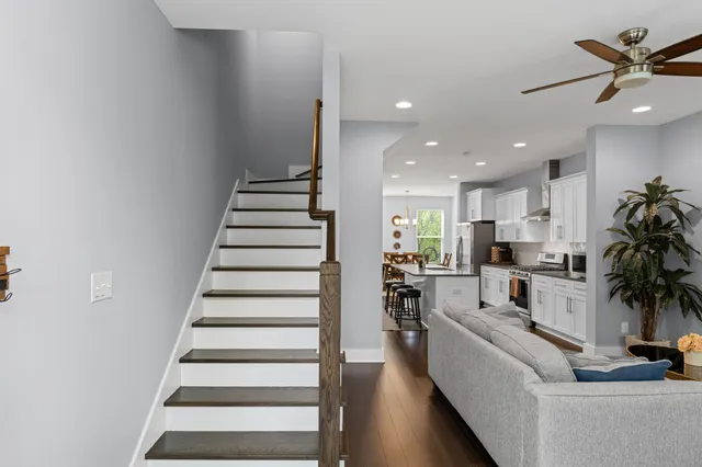 a living room with furniture and a chandelier