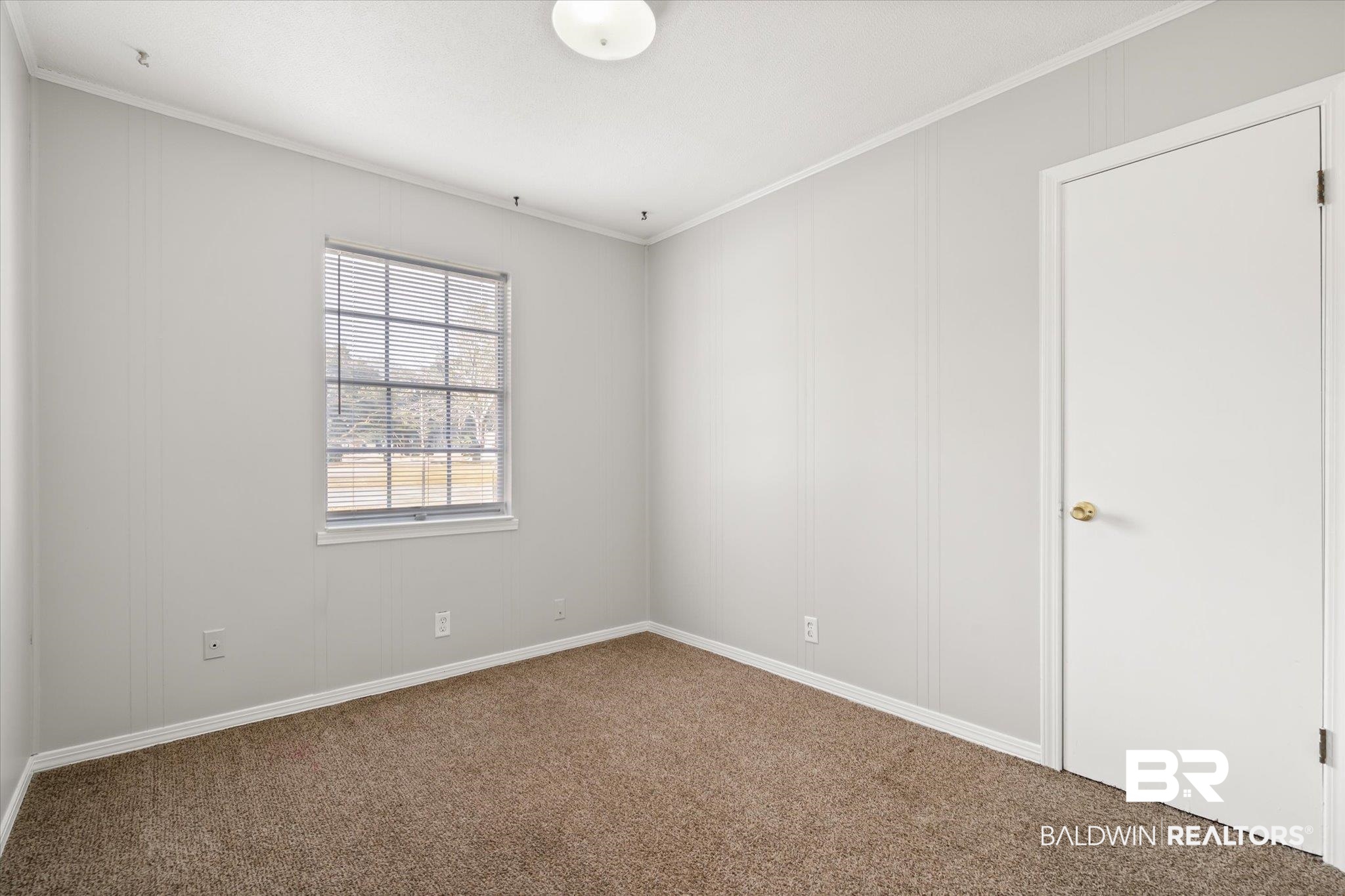 6848 Sandra Drive Theodore, AL 36582 - Photo 5 of 21 Spare room featuring crown molding and carpet