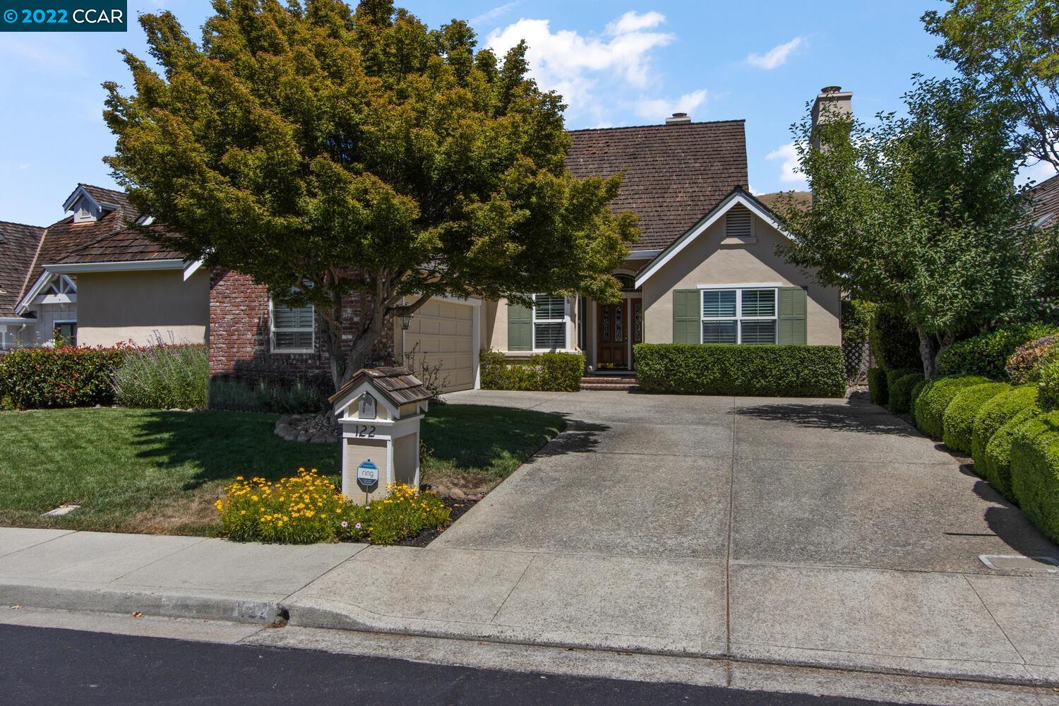 a front view of a house with a yard and garage