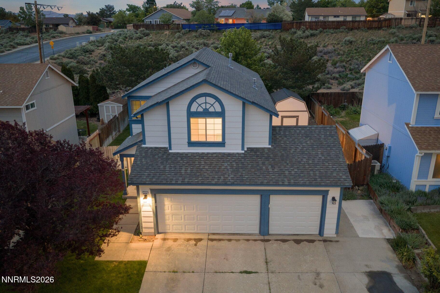8486 Piper Place Reno, NV 89506 - Photo 75 of 80 a front view of a house with a yard and garage