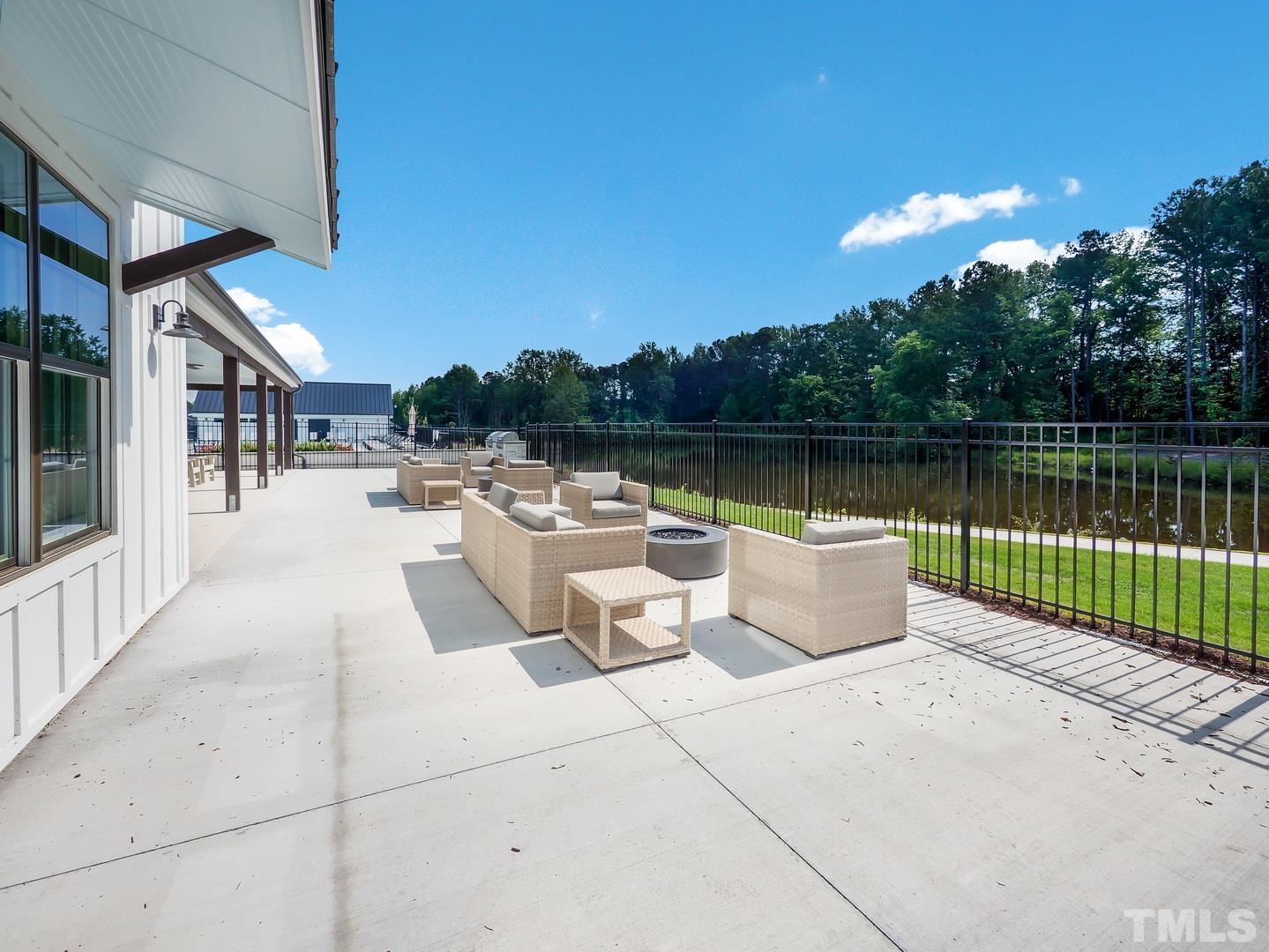 2997 Rise And Shine Road, Unit 559 WALKER A Apex, NC 27502 - Photo 11 of 14 a view of a lake with a patio