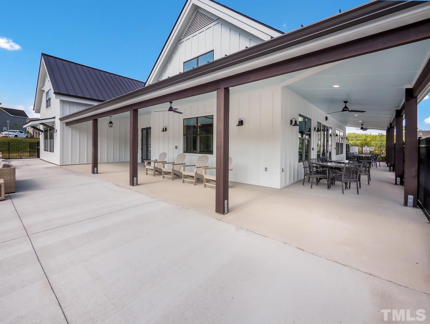 2997 Rise And Shine Road, Unit 559 WALKER A Apex, NC 27502 - Photo 13 of 14 a view of a patio with table and chairs