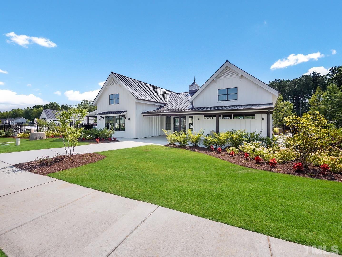 2997 Rise And Shine Road, Unit 559 WALKER A Apex, NC 27502 - Photo 4 of 14 a front view of a house with a garden and plants