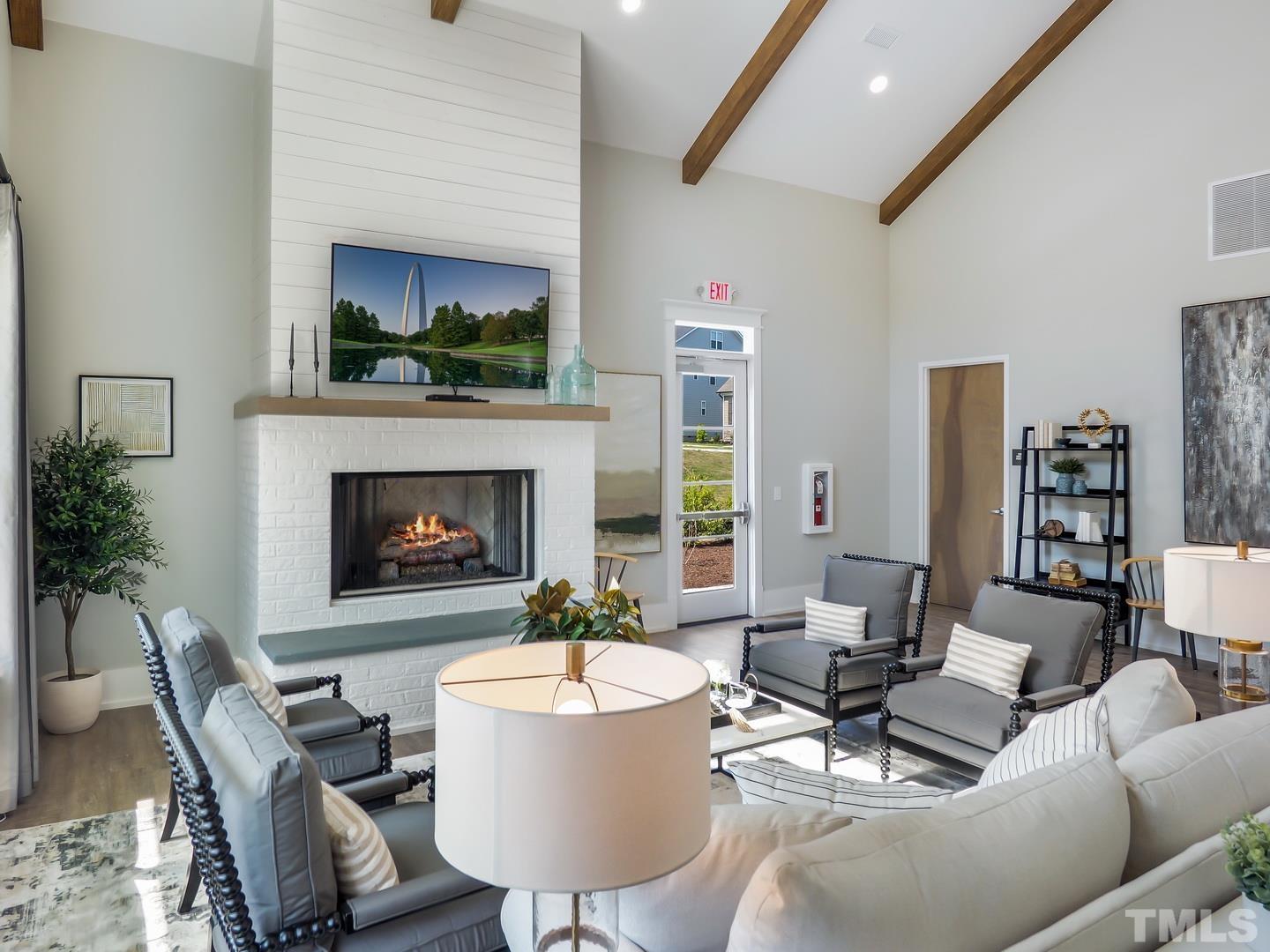 2997 Rise And Shine Road, Unit 559 WALKER A Apex, NC 27502 - Photo 10 of 14 a living room with furniture a fireplace and a table