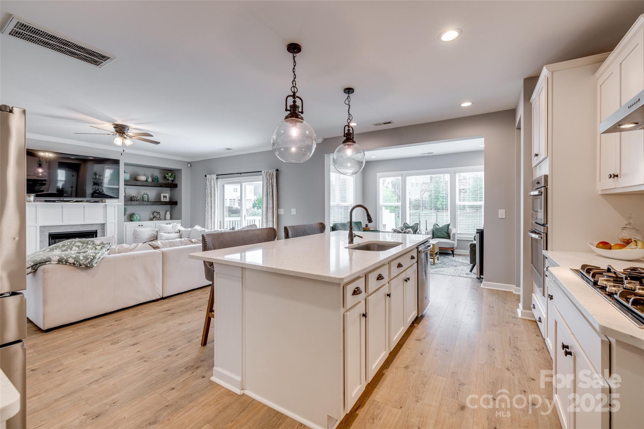 5431 Meadowcroft Way Fort Mill, SC 29708 - Photo 12 of 40 a large white kitchen with cabinets a counter top space a sink and stainless steel appliances