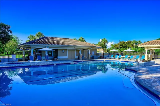 a view of house with outdoor space and swimming pool