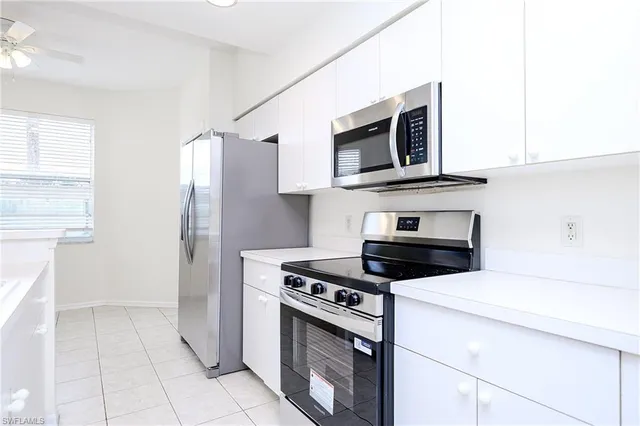 a kitchen with cabinets and steel stainless steel appliances