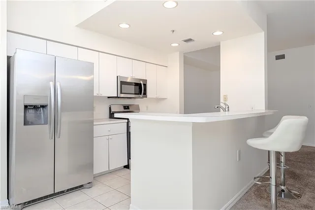 a kitchen with cabinets and stainless steel appliances