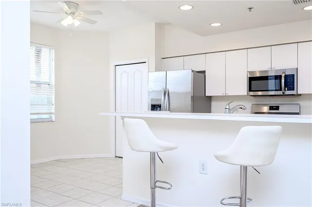 a kitchen with stainless steel appliances a stove a sink and a refrigerator