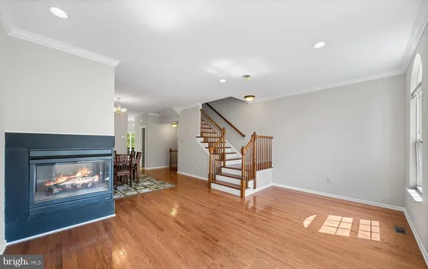 a view of empty room with wooden floor fireplace and window