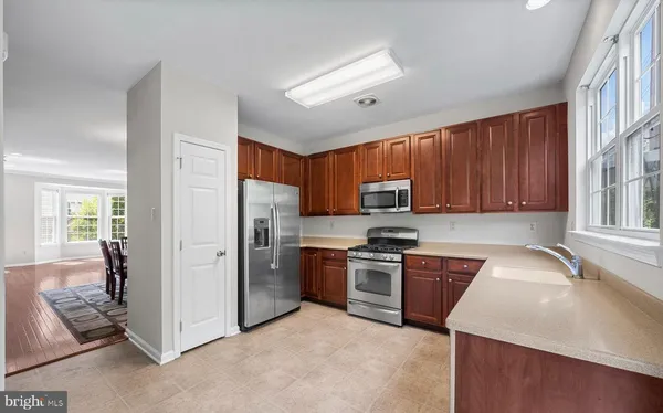 a bathroom with a toilet sink vanity and mirror