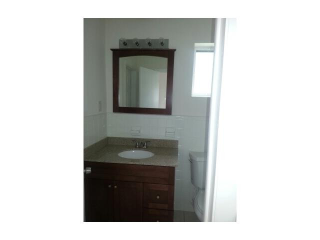 5521 Buchanan Street Hollywood, FL 33021 - Photo 12 of 12 a bathroom with a sink and a mirror