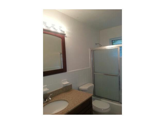 5521 Buchanan Street Hollywood, FL 33021 - Photo 7 of 12 a bathroom with a sink toilet and mirror