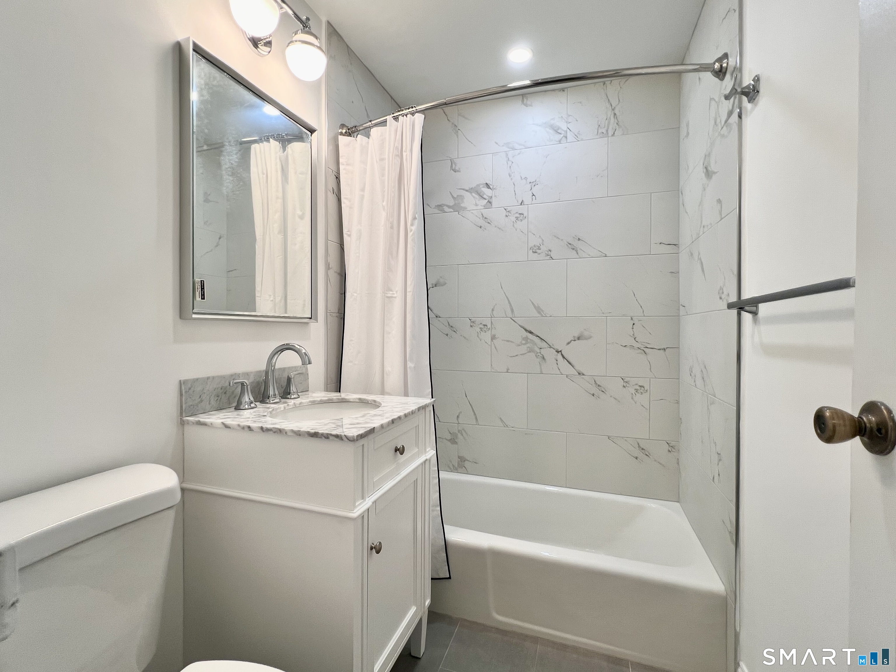 208 Flax Hill Road, Unit 32 Norwalk, CT 06854 - Photo 6 of 12 a bathroom with a granite countertop sink a toilet and shower
