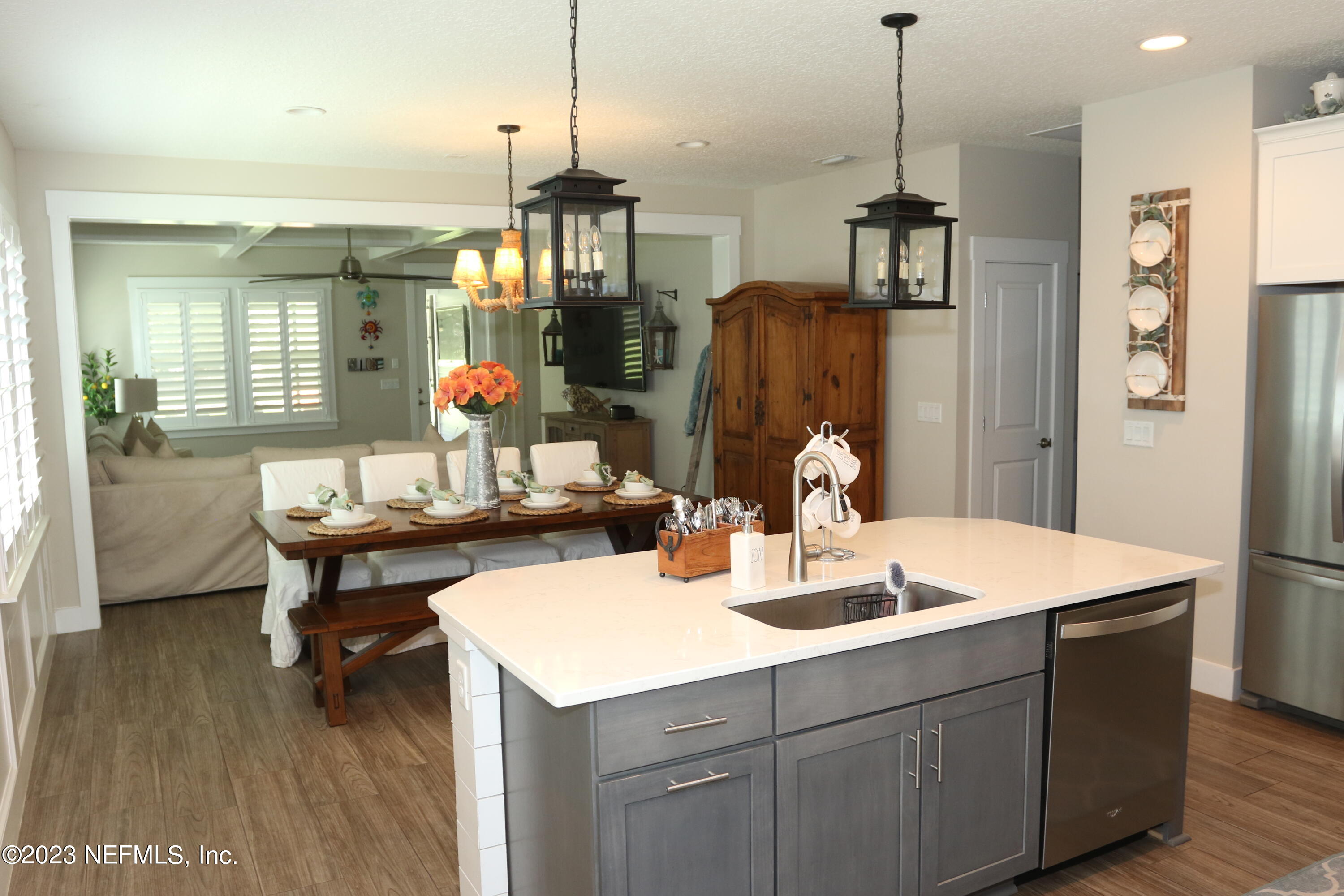 3836 Collins Road Jacksonville, FL 32244 - Photo 16 of 40 a kitchen with a sink a refrigerator and chairs