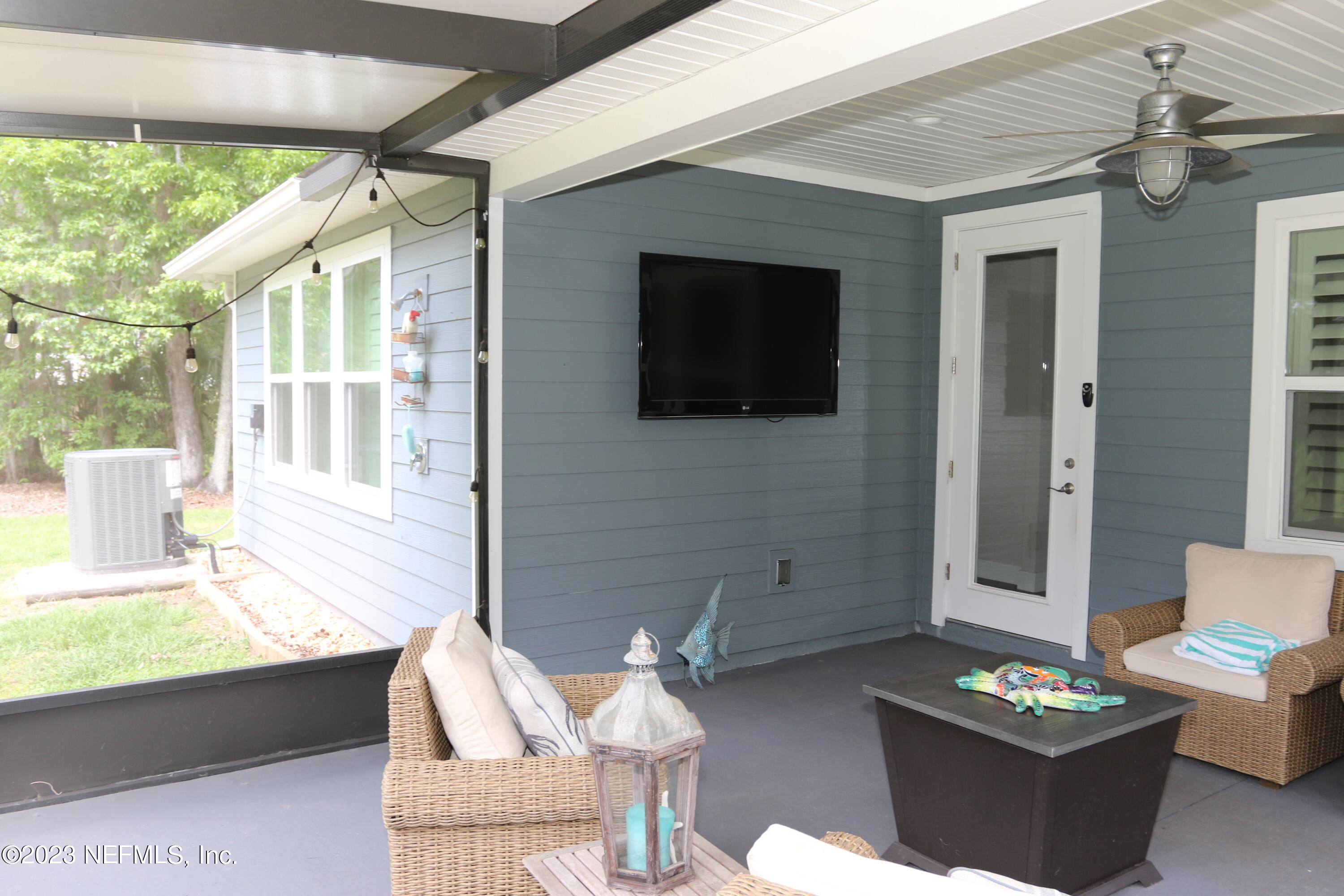3836 Collins Road Jacksonville, FL 32244 - Photo 19 of 40 a living room with furniture a flat screen tv and a window