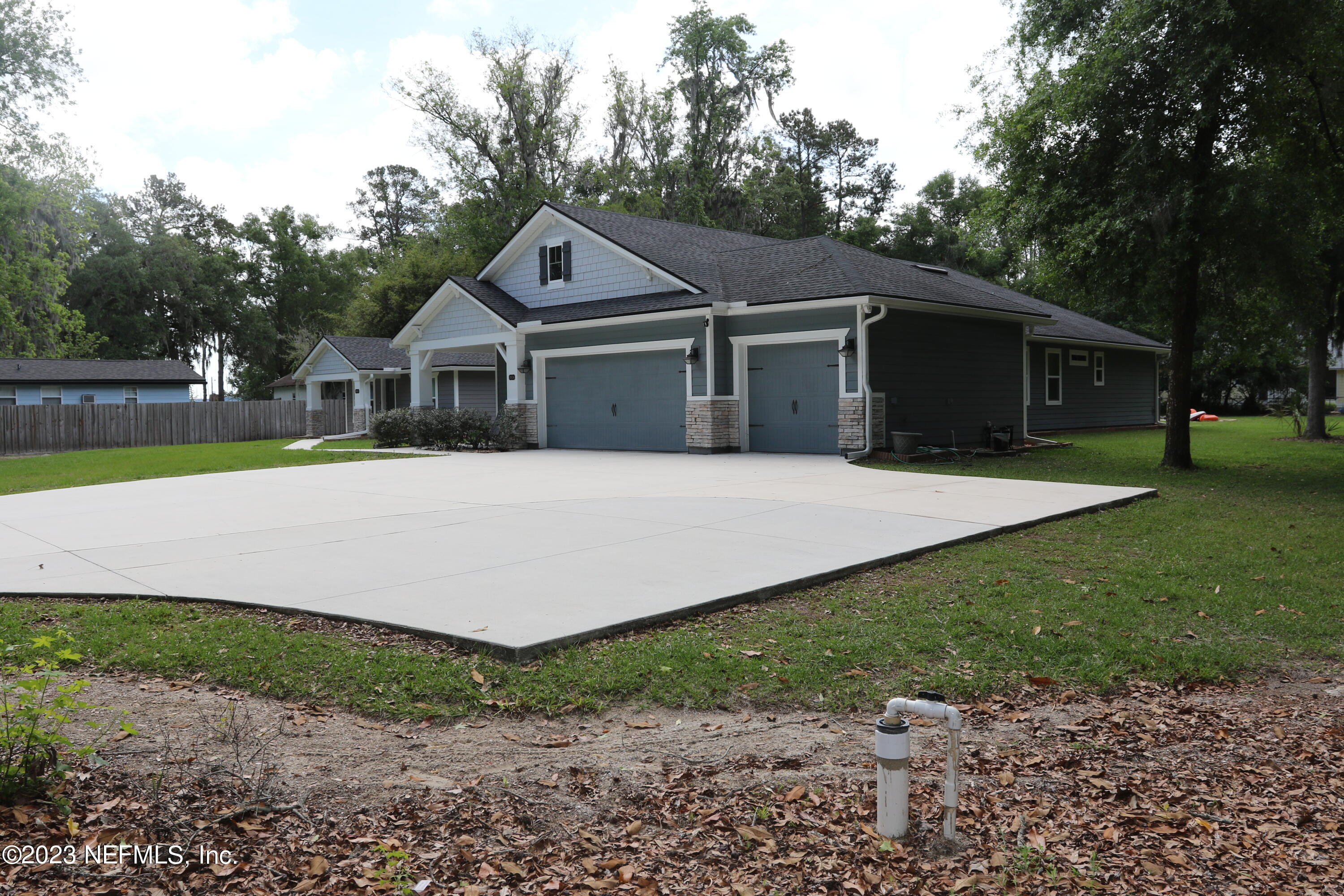3836 Collins Road Jacksonville, FL 32244 - Photo 2 of 40 a front view of a house with a garden and yard