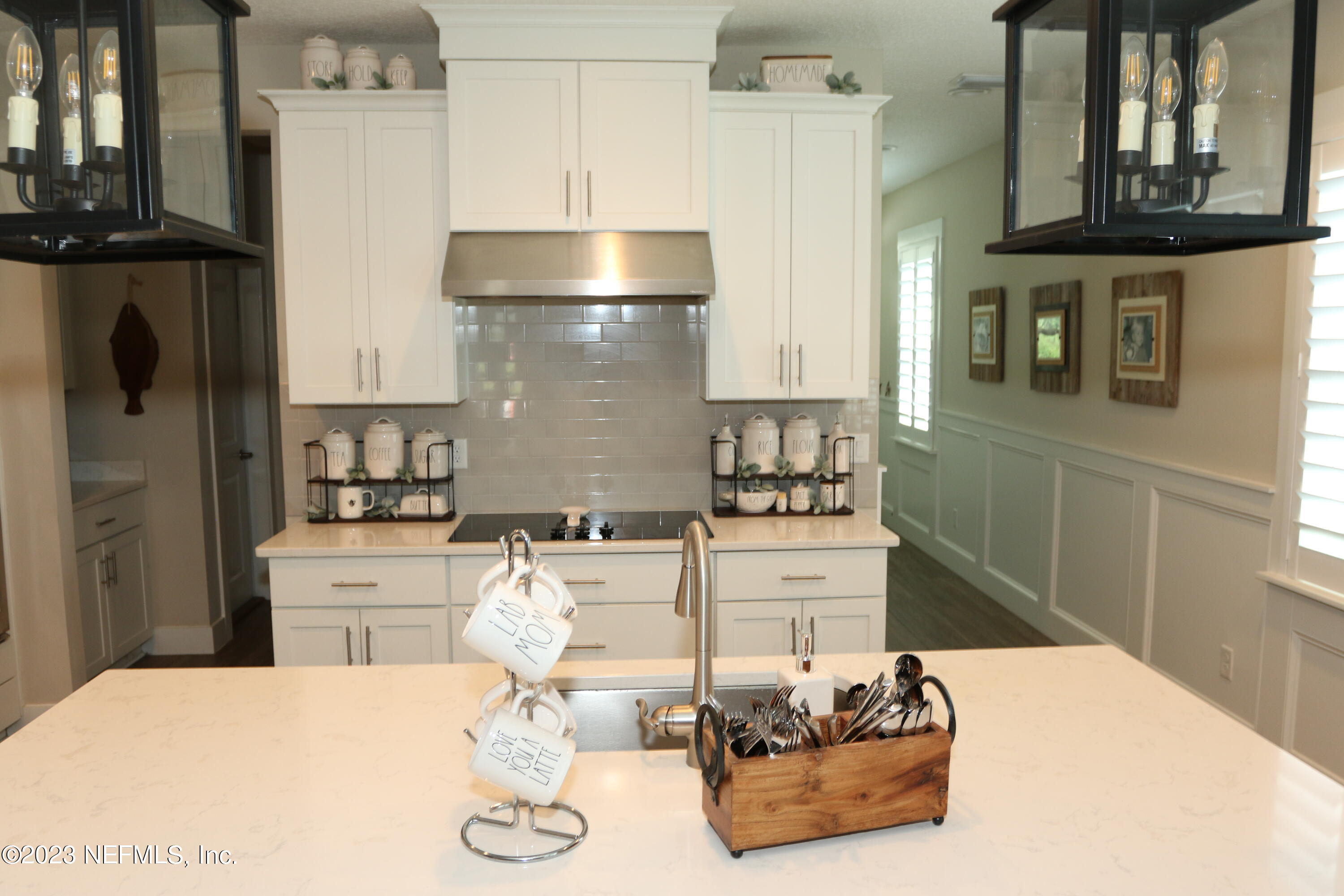 3836 Collins Road Jacksonville, FL 32244 - Photo 22 of 40 a kitchen with stainless steel appliances kitchen island granite countertop a refrigerator and a stove top oven