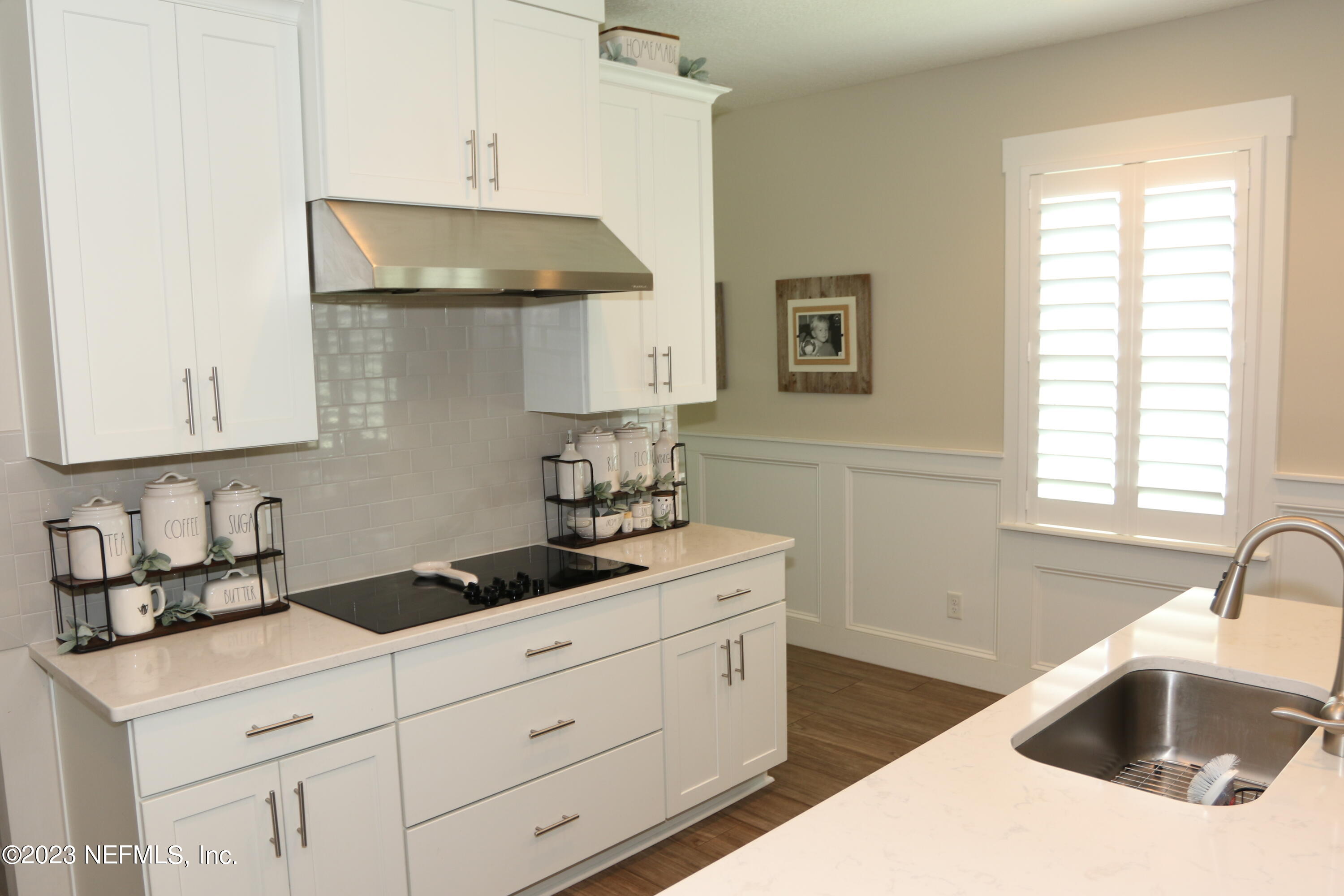 3836 Collins Road Jacksonville, FL 32244 - Photo 24 of 40 a kitchen with stainless steel appliances a sink a stove and cabinets