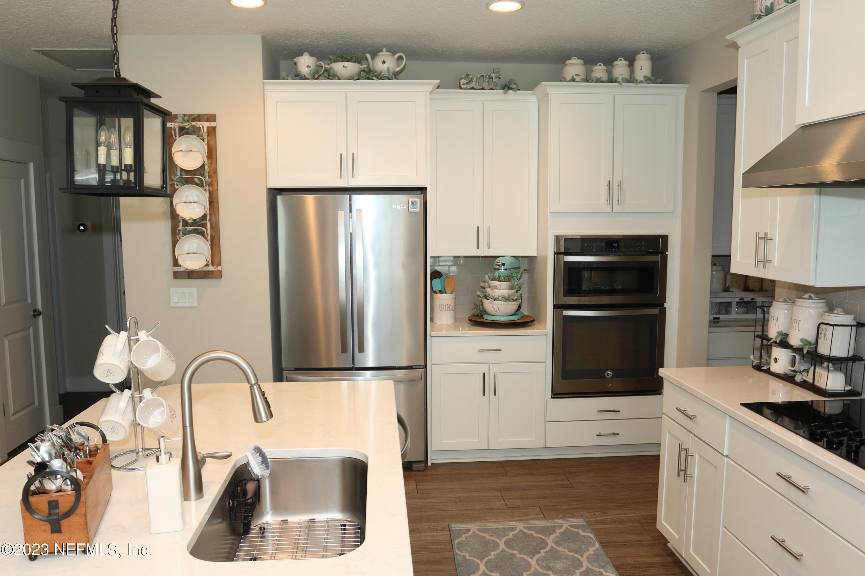 3836 Collins Road Jacksonville, FL 32244 - Photo 26 of 40 a kitchen with granite countertop a refrigerator and a sink