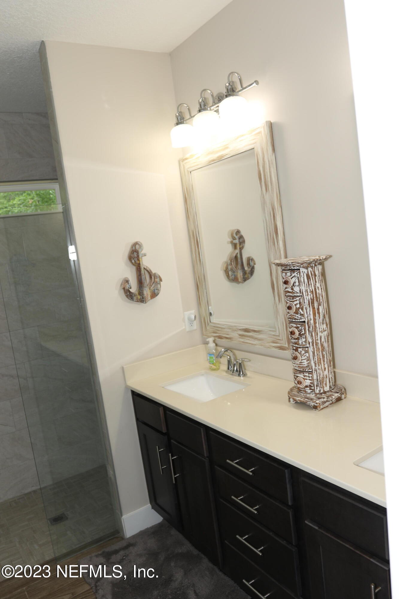 3836 Collins Road Jacksonville, FL 32244 - Photo 31 of 40 a bathroom with a sink a mirror and vanity