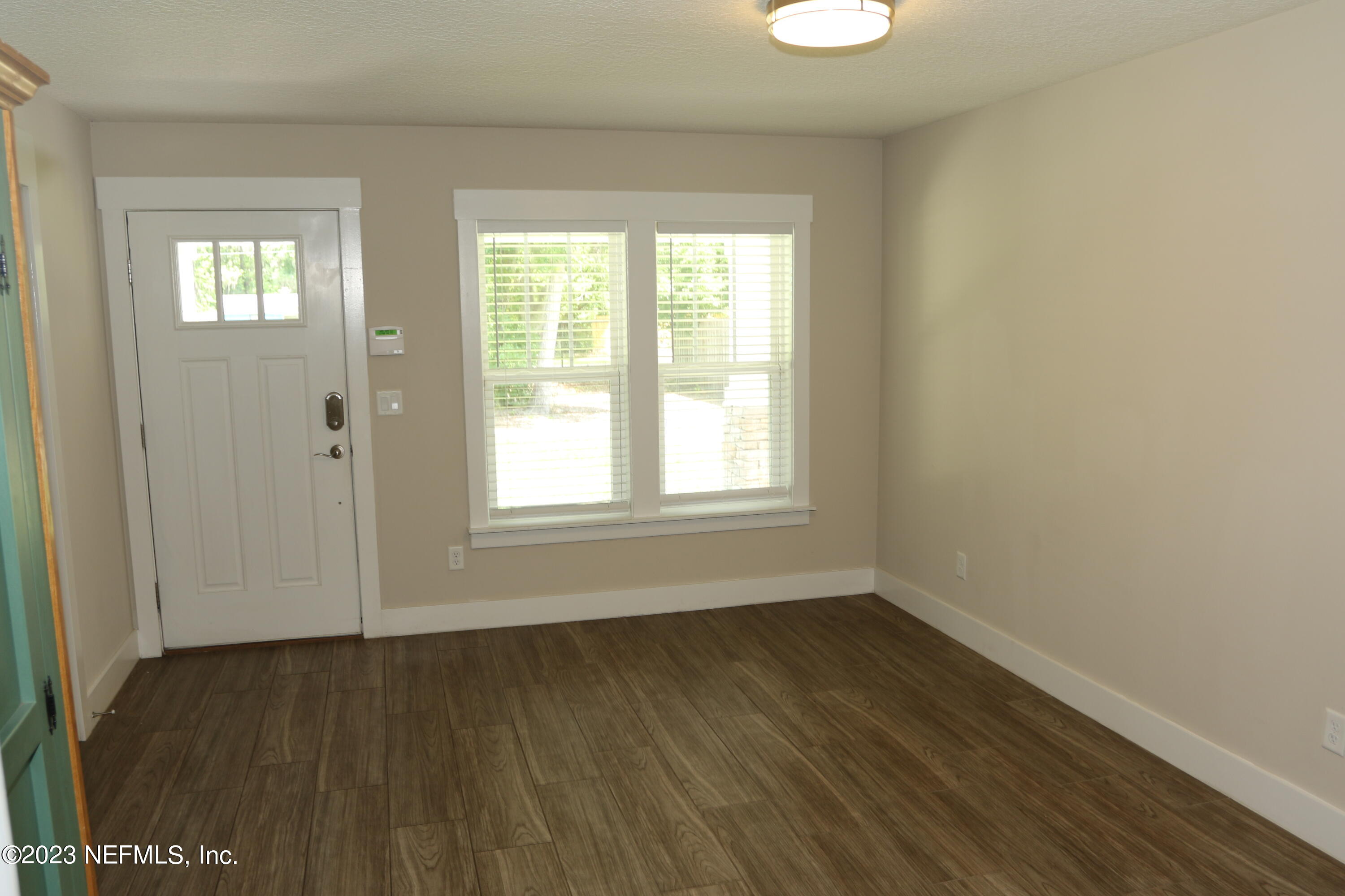 3836 Collins Road Jacksonville, FL 32244 - Photo 32 of 40 an empty room with wooden floor and windows