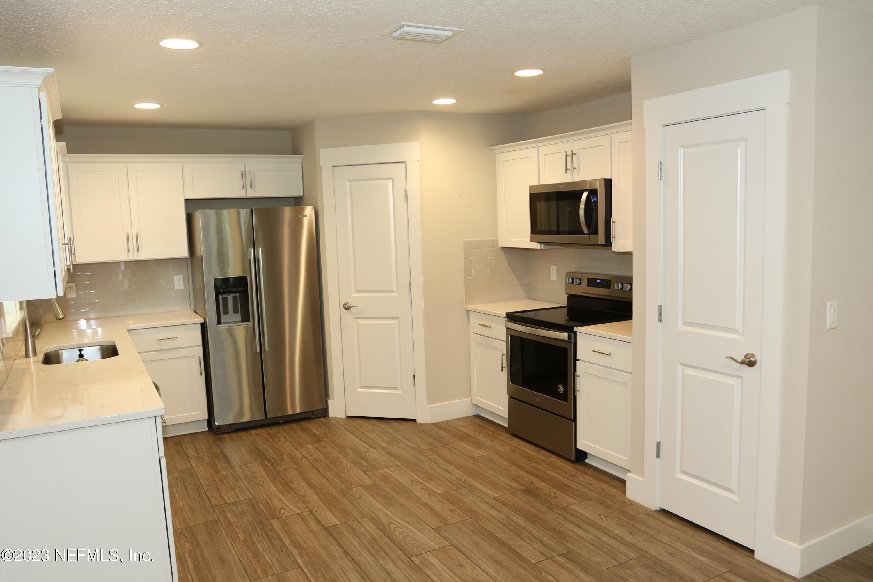 3836 Collins Road Jacksonville, FL 32244 - Photo 33 of 40 a kitchen with a refrigerator a stove top oven and sink