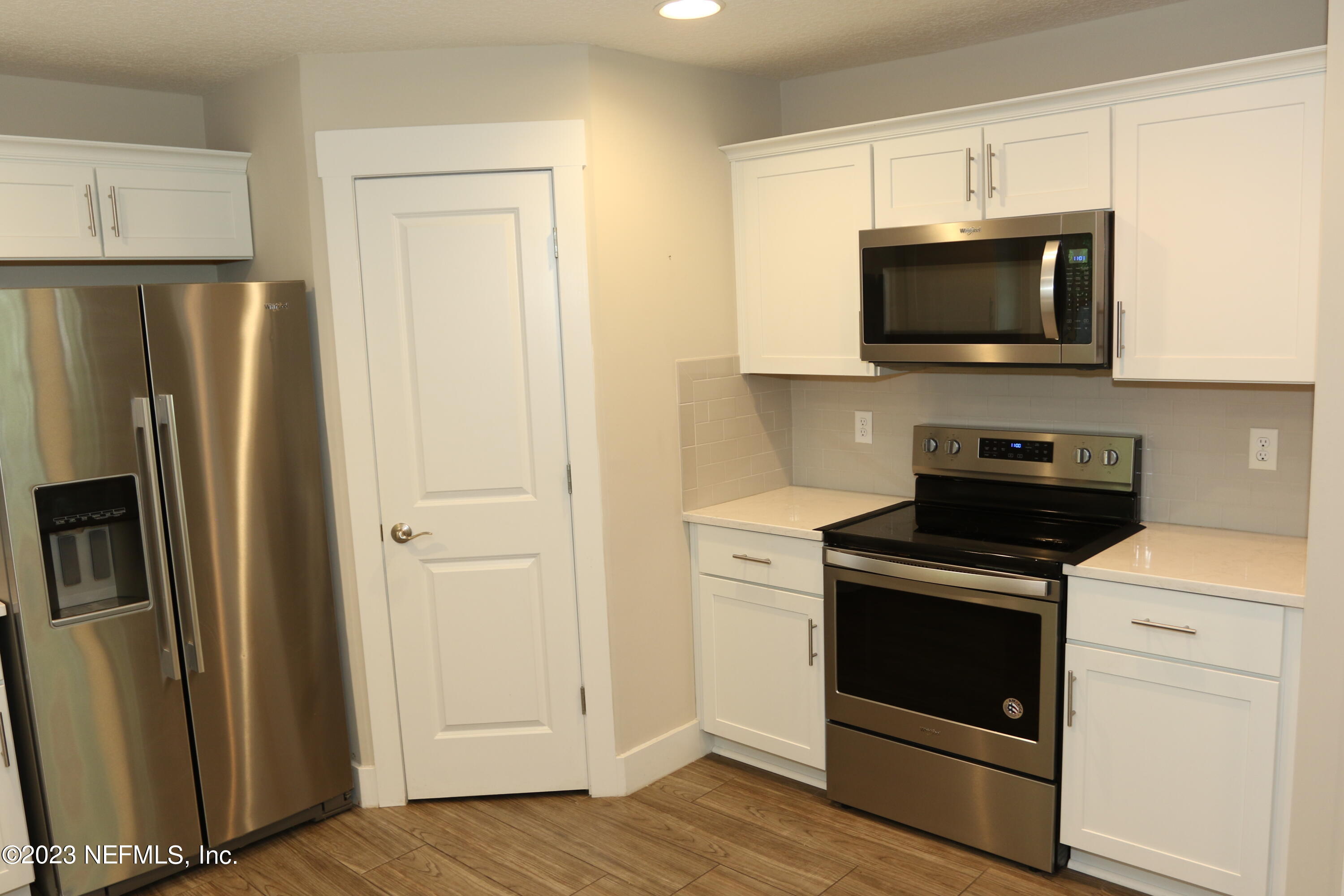 3836 Collins Road Jacksonville, FL 32244 - Photo 35 of 40 a kitchen with stainless steel appliances a stove a microwave and a hard wood floors