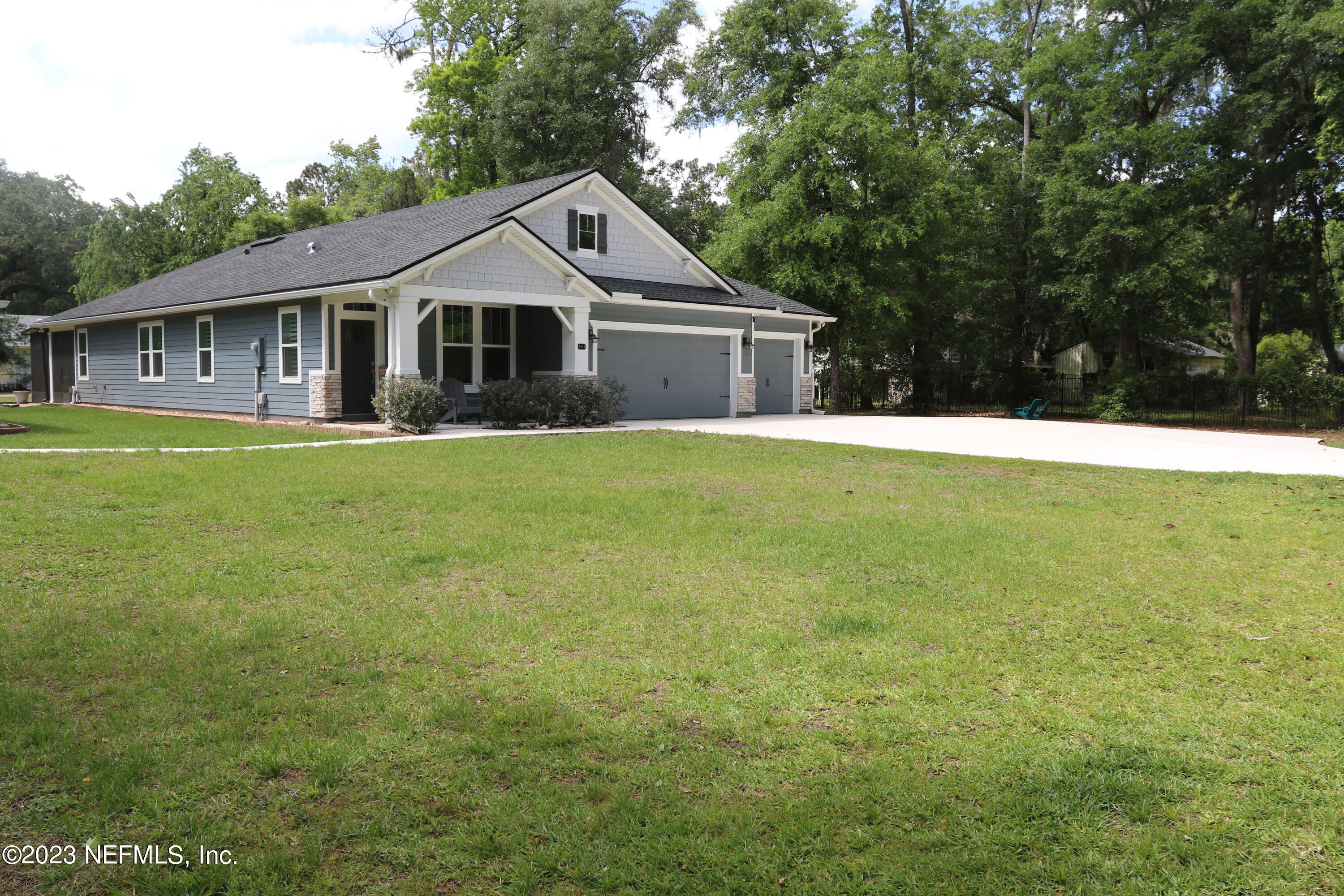 3836 Collins Road Jacksonville, FL 32244 - Photo 5 of 40 a front view of a house with a garden