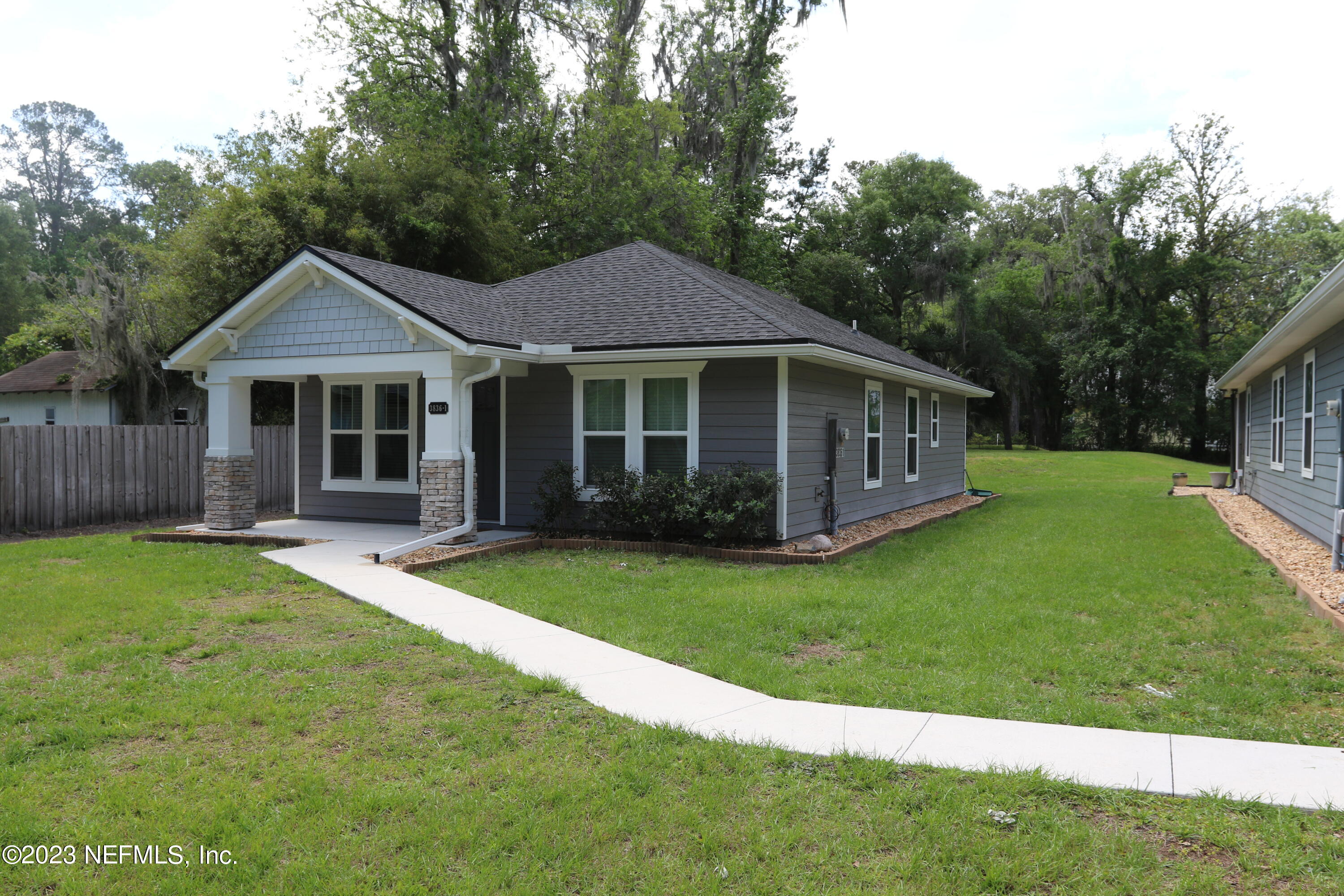 3836 Collins Road Jacksonville, FL 32244 - Photo 6 of 40 a front view of a house with a garden