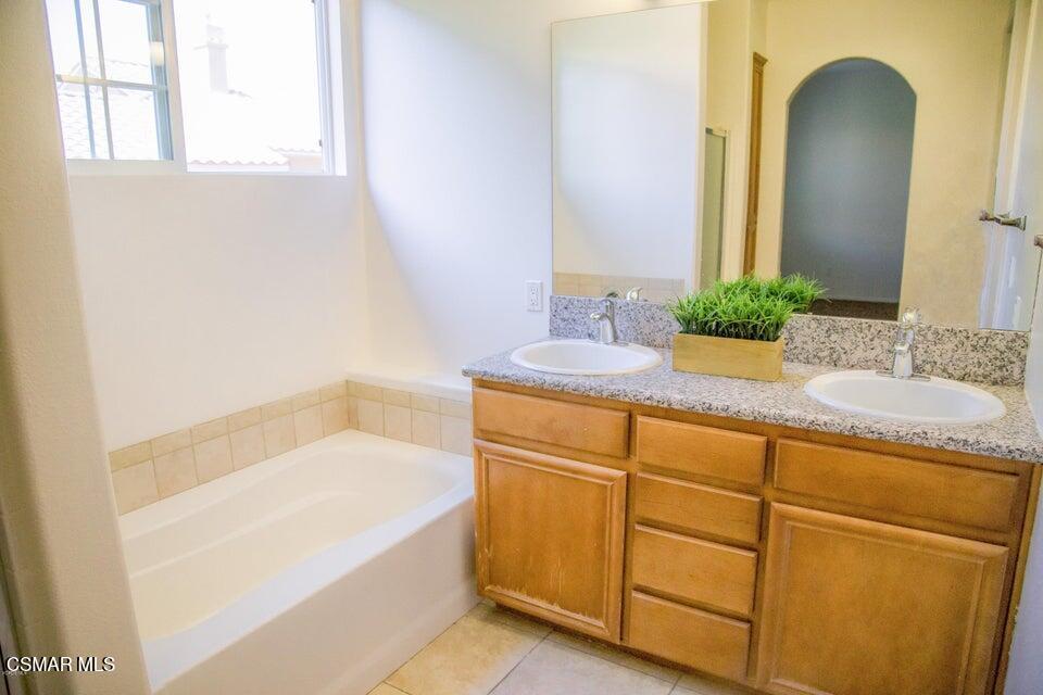 1480 Patricia Avenue, Unit 11 Simi Valley, CA 93065 - Photo 3 of 4 a bathroom with a granite countertop sink and a mirror