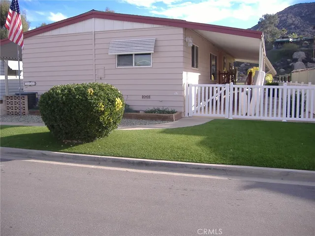 a view of a house with a yard and garage