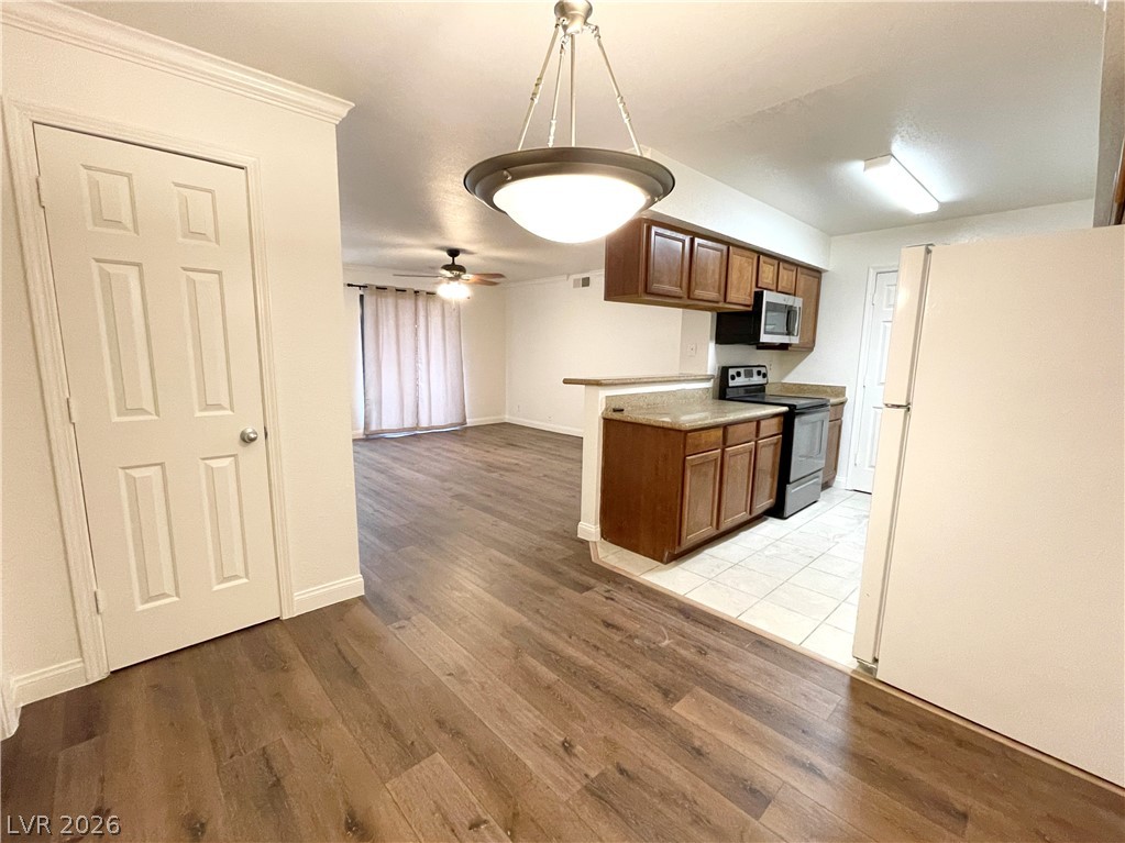 3135 South Mojave Road, Unit 221 Las Vegas, NV 89121 - Photo 5 of 19 An inviting open-concept layout connects the well-appointed kitchen with warm wooden cabinetry to the living area.