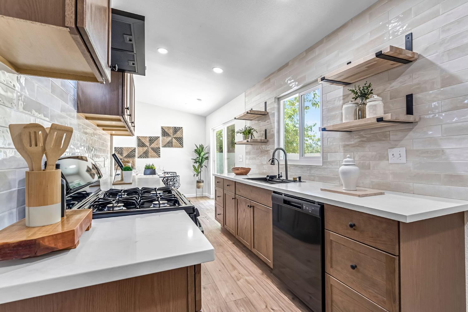27208 Saunders Road Madera, CA 93637 - Photo 13 of 27 a kitchen with stainless steel appliances a sink stove and cabinets